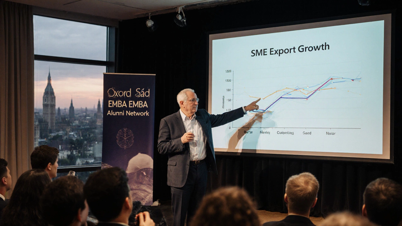 An older man speaking at a symposium about SME growth, with an attentive audience behind him.
